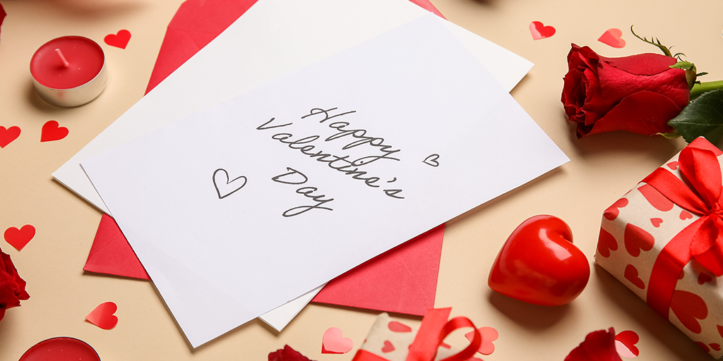 A card with the message Happy Valentine's Day written on it laying on the table.