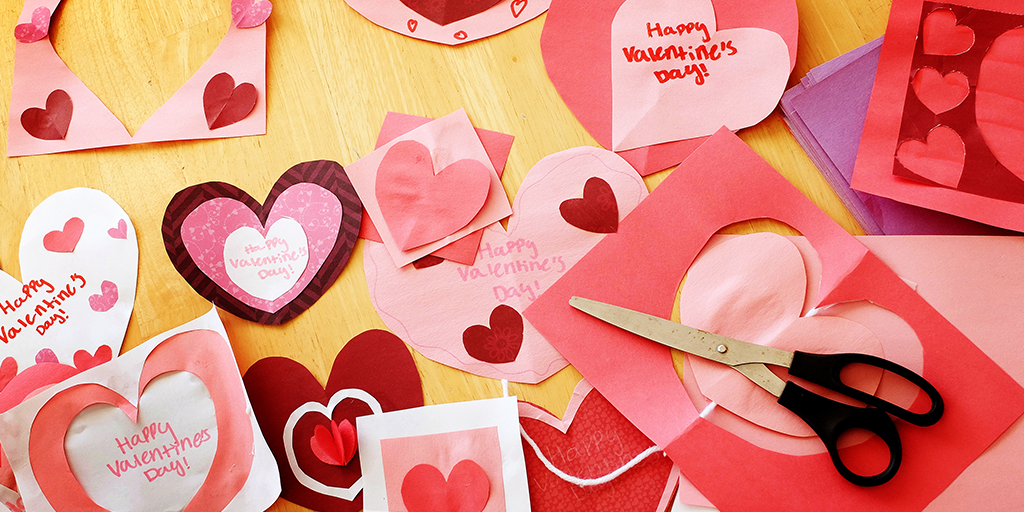 Heart shaped paper cutouts spread across the table