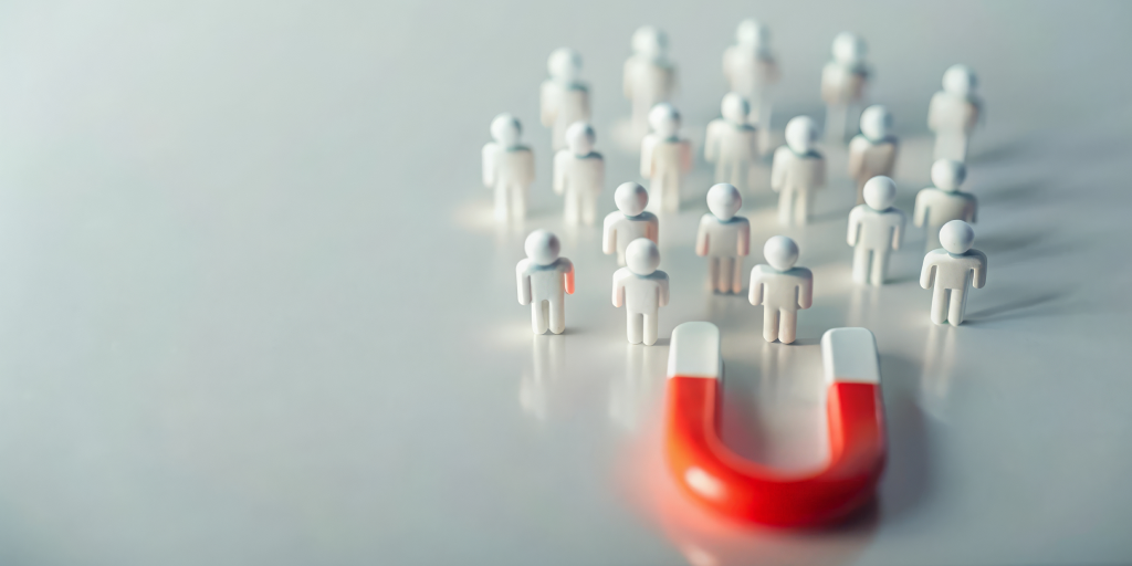 A magnet attracting miniature toys of people.